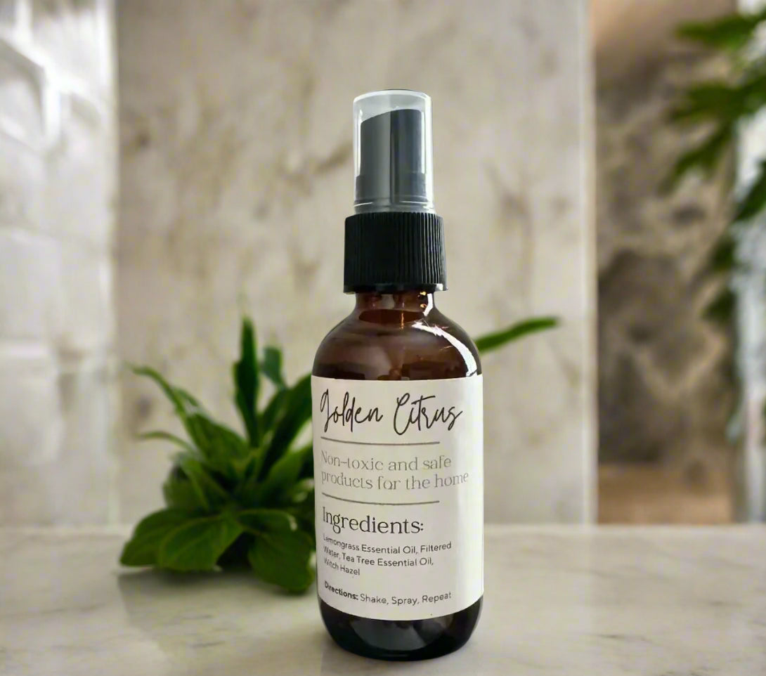 Eco-friendly air freshener in glass spray bottle made with non-toxic lemongrass essential oils to remove odors.